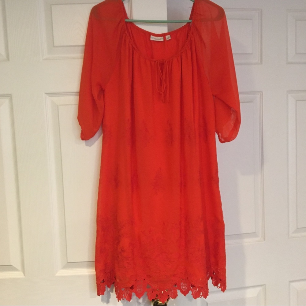 Orange knee length dress.